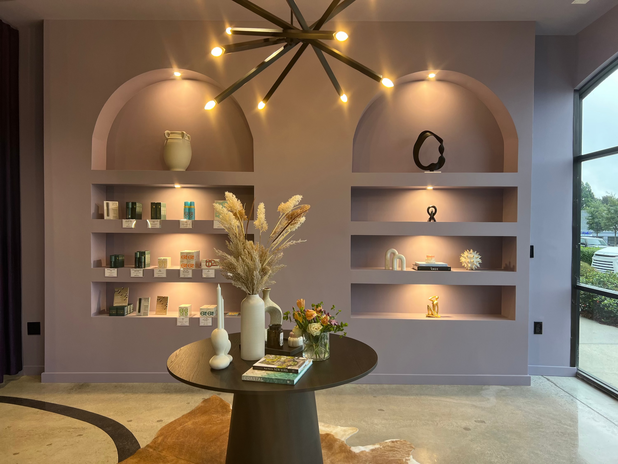 Modern interior with shelves, a table, and decorative items in a well-lit room.